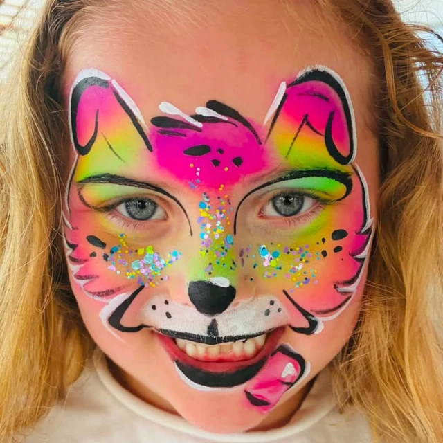 A smiling child with bright rainbow tiger face paint and glitter